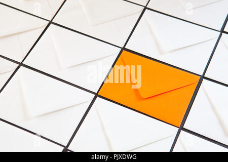Composition with white and orange envelopes on the table. Different colored envelopes on the table. Stock Photo