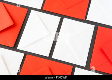 Composition with white and red  envelopes on the table. Different colored envelopes on the table. Stock Photo