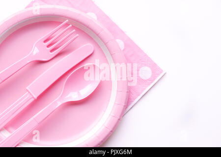 Pink color paper plate with plastic spoon, fork and knife Stock Photo