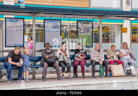 People waiting for a bus, Bristol, England, UK Stock Photo