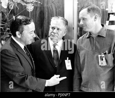 Cape Canaveral, FL - (FILE) -- United States Representative Bert Podell (Democrat of New York), left, speaks with U.S. Representative Olin E. Teague (Democrat of Texas), Chairman of the Manned Spaceflight Subcommittee, center, and Neil A. Armstrong, Apollo 11 mission commander, right, on February 28, 1969.  Credit: NASA via CNP /MediaPunch Stock Photo