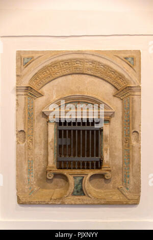 A small window with a lattice in an old church for candle Stock Photo