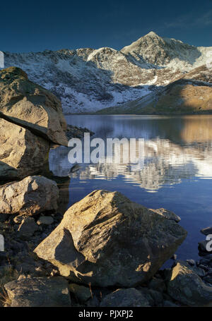 Snowdon mountain in winter, reflecting in the waters of Llyn Llydaw, Snowdonia, North Wales Stock Photo