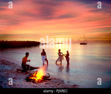 BS - GRAND CAY: Group of young people having barbeque on beach Stock Photo