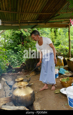 Cooking Food  Outdoors Using Fire Woods in Village Stock Photo