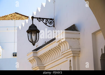 low angle view of a vintage street lamp on a traditional building - Asilah, Morocco Stock Photo