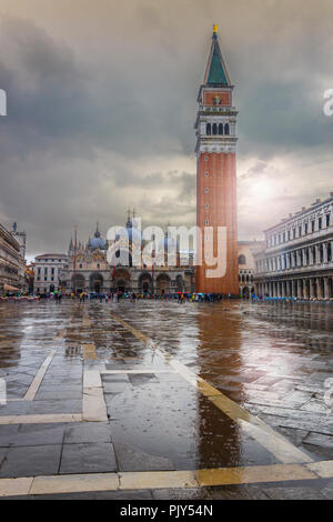 San Marco square under the rain with Bell Tower and Saint Mark's Basilica. The main square of the old town. Venice, Italy. Stock Photo