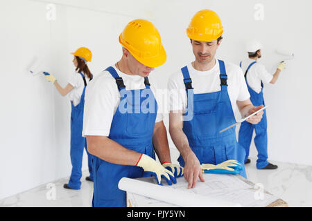 Workers discuss renovation project using digital tablet Stock Photo