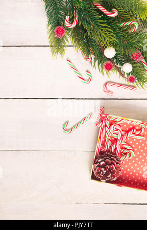 Lots of candy canes on gift box with big bow. Stock Photo