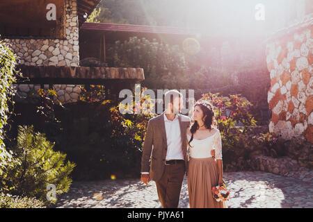 Couple walking in the manor at sunset light. Casual style clothes Stock Photo