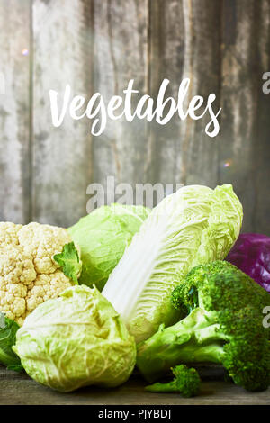 Many sorts of cabbage on rustic wooden background Stock Photo