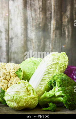 Many sorts of cabbage on rustic wooden background Stock Photo