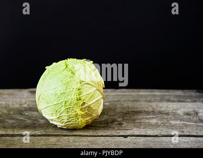 Fresh green garden cabbage on wooden rustic background Stock Photo