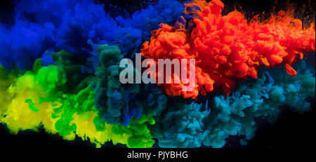 Mix of coloured inks in water on black background. Abstract colored background Stock Photo