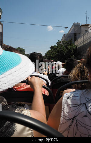 Tourists on the top of a tour bus in Rome, Italy Stock Photo