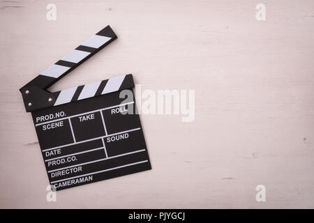 Clapper open on wooden table. Concept of editing and production of videos. Horizontal composition Top view Stock Photo