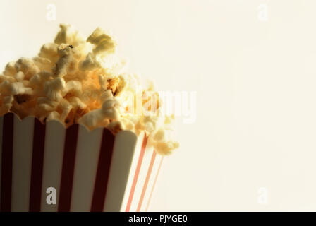 Popcorn in cardboard box with white background vintage. Horizontal composition. Front view. Stock Photo