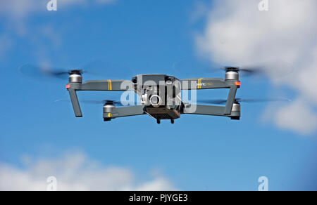 A pilotless drone hovering in the sky Stock Photo