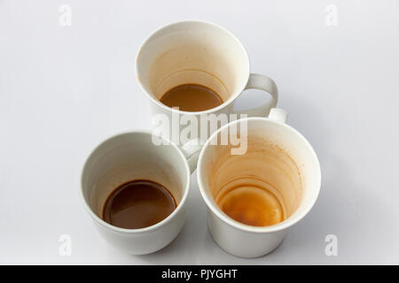 A Close up top view of three dirty white coffee mugs in a group on a isolated white background Stock Photo