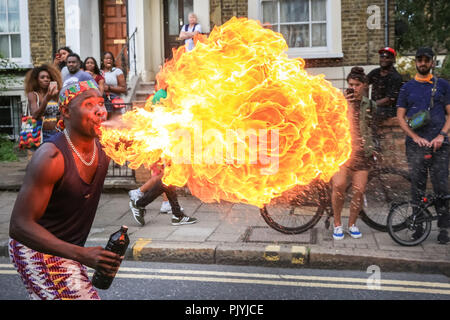 Hackney, London, 9th Sep 2018. A fire-eater, or fire spitter,  performing with GAHU Dramatic Arts.The annual Hackney Carnival sees over 1,000 performers, dancers and musicians participate in the festivities in the North London suburb. The carnival, originally with Afro-Caribbean roots, includes many local communities but also attracts revellers and performers from a variety of other cultural backgrounds. Credit: Imageplotter News and Sports/Alamy Live News Stock Photo