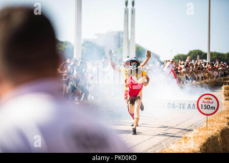 Lisbon, Portugal. 9th Sep, 2018. After having an accident and leaving the car, the participants continue the journey on foot at the 3rd Grand Prix Red Bull in Lisbon known as ''The Crazy Race in the World''.''The Crazy Race in the World'' is an event for amateur riders racing on handmade cars. The vehicles move by creativity and friendly competition, without ever forgetting the speed adrenaline. This race of vehicles without motor, proposes to the participants the construction of a car that defies the norms of the design and the laws of the physics. They will compete against the clock o Stock Photo