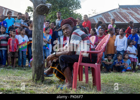 BAJAWA, INDONESIA - MAY 19: Unidentified crowds gather behind the village chief for traditional boxing near Bajawa in East Nusa Tenggara, Indonesia on Stock Photo
