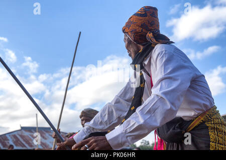 BAJAWA, INDONESIA - MAY 19: An unidentified man dances near  Bajawa in East Nusa Tenggara, Indonesia on May 19, 2017. Stock Photo