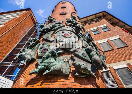 bronce sculpture of the 12 Zodiac signs by swedish sculptor Walter Bengtsson, at the red brick architecture of apartment house Föringsgatan 15 in Malm Stock Photo