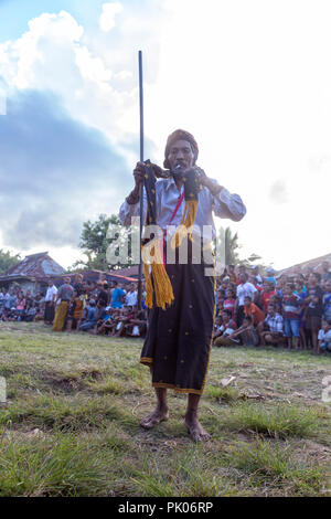 BAJAWA, INDONESIA - MAY 19: Unidentified man smokes and dances near  Bajawa in East Nusa Tenggara, Indonesia on May 19, 2017. Stock Photo