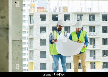 Serious construction designers viewing sketch Stock Photo
