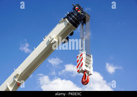 Boom of mobile crane with blue sky background. Stock Photo