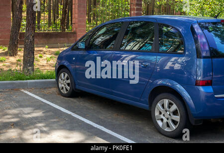 A fragment of a modern car in the Parking lot near the Park. Side view. Stock Photo