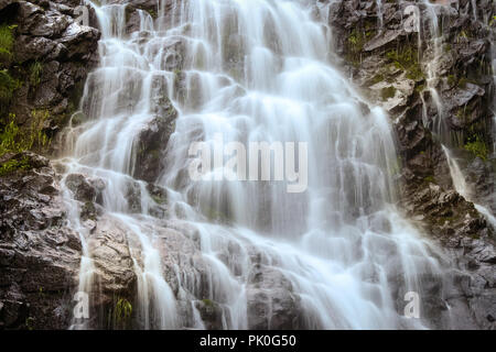 Close-up long exposure of powerful Piljski waterfall cascading down the rocky cliff during spring on Old mountain Stock Photo