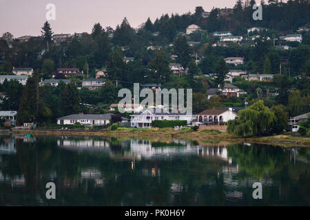 Nanaimo city, residential houses on a sea shore in a misty sunset scenery, Vancouver Island, British Columbia, Canada. Stock Photo