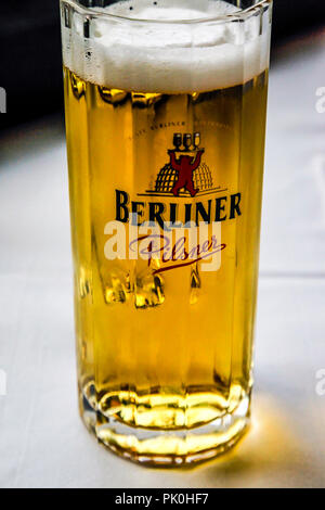 Glasses of Berliner Pilsner beer with foamy head sitting on a restaurant table in Berlin, Germany Stock Photo