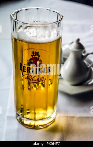 Glasses of Berliner Pilsner beer with foamy head sitting on a restaurant table in Berlin, Germany Stock Photo