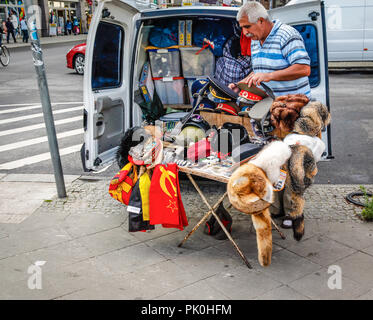 Man selling cold war souvenirs from his van near Checkpoint Charlie in Berlin, Germany Stock Photo