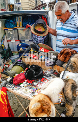Man selling cold war souvenirs from his van near Checkpoint Charlie in Berlin, Germany Stock Photo
