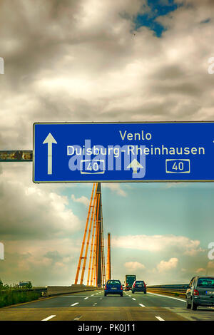 Directional overhead motorway sign before Bridge over the Ruhr on A-40 autobahn near Duisburg in Germany Stock Photo