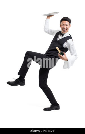 Cheerful young waiter serving food Stock Photo