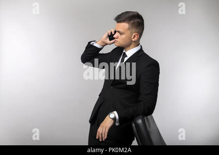 Businessman talking on mobile phone in office Stock Photo