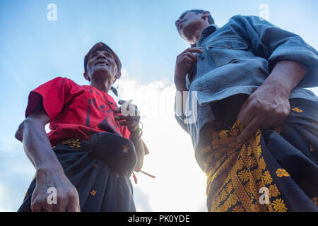 BAJAWA, INDONESIA - MAY 19: Unidentified Flores men look at a crowd of people near  Bajawa in East Nusa Tenggara, Indonesia on May 19, 2017. Stock Photo