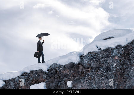 Businessman walking with umbrella and keeping her business. Stock Photo