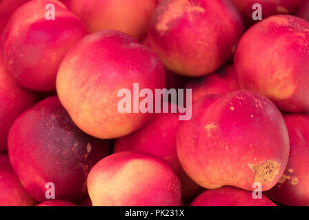 Lot of ripe nectarines in the supermarket. Stock Photo
