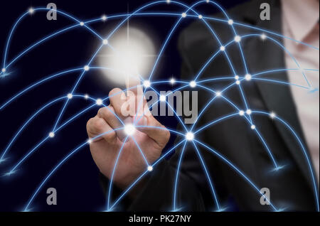 Businessman pointing with digital network line and circles on dark background, business technology concept Stock Photo