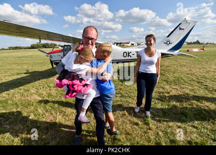 A show of original historical planes and their replicas could be seen at the 9th Letnany Airport Day in Prague, Czech Republic, on September 8, 2018, held on the occasion of the 100th anniversary of the foundation of the Czechoslovak air force and the 60th anniversary of the production of the Blanik glider. In the afternoon, acrobatic pilot Roman Kramarik (pictured with family), the first Czech to fly around the world in a small Cessna P210N plane, landed at the Letnany Airport, ending his mission that started at the Tocna airfield on the outskirts of Prague on July 25. (CTK Photo/Vit Simanek) Stock Photo