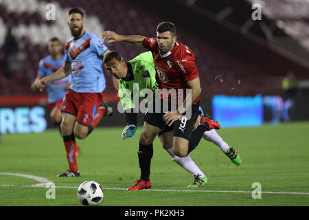Buenos Aires, Argentina. 10th September, 2018. Emanuel Gigliotti (independiente) is tackled by the Brown goalkeeper and gain a penalty kick in the progress in Buenos Aires, Argentina. Credit: Canon2260/Alamy Live News Stock Photo