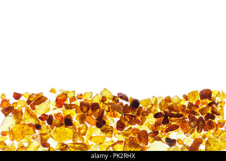 Amber abstract background made of small pieces lying at the bottom Stock Photo