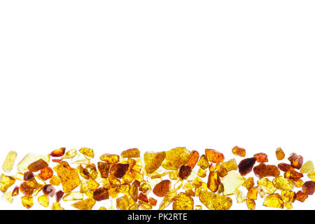 Amber abstract background made of small pieces lying at the bottom Stock Photo