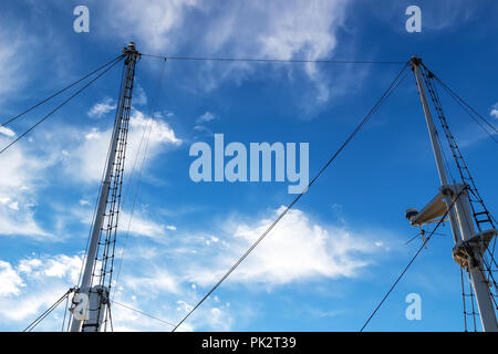 Two masts of a ship against the blue sky Stock Photo